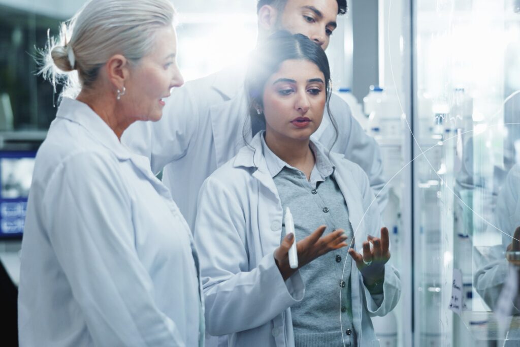 Clinical experts reviewing and discussing patient data in a laboratory setting as part of an independent critical event assessment process